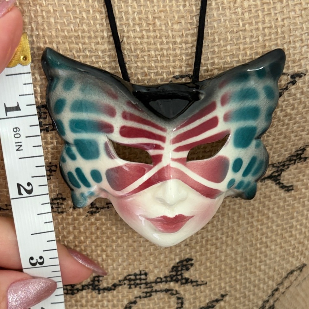 Butterfly Mask Pendant Necklace on a silk rope .